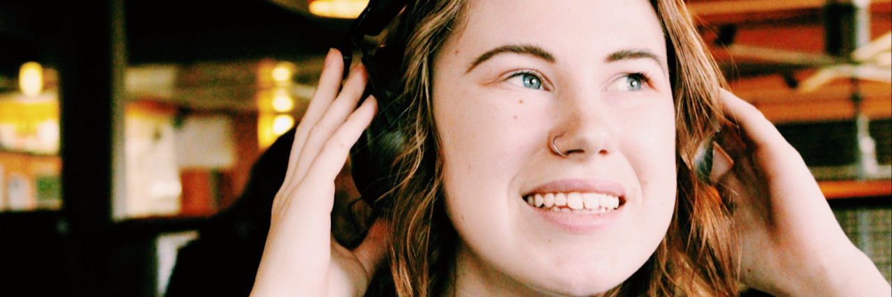 Autism and Adulthood: Some Coping Strategies as I Start College woman with ear defenders on