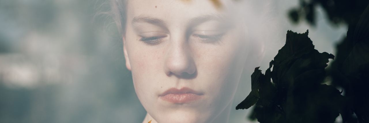 When You Contemplate What It Means to Live a Full Life With Depression woman covered in tree shadow looks contemplative