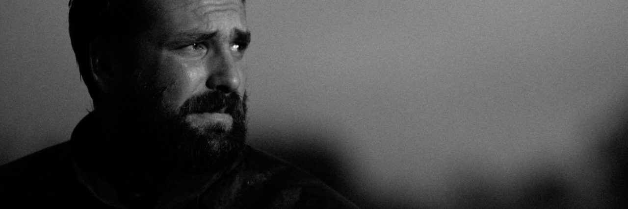 The Surprising Link Between Facial Hair and PTSD in Male Veterans black and white photo of unhappy man with beard looking into distance