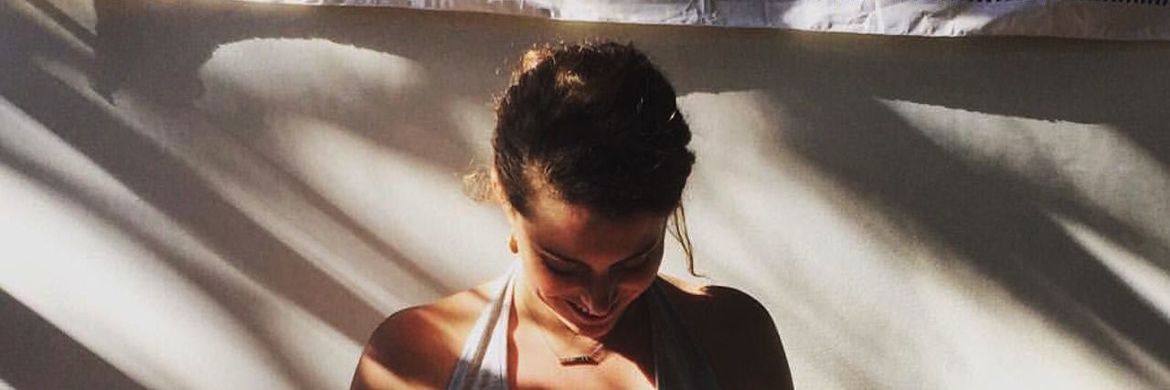 How Mindfulness Can Help Manage Retinitis Pigmentosa and Loss of Sight martel sitting in a yoga position with sunlight beaming down on her