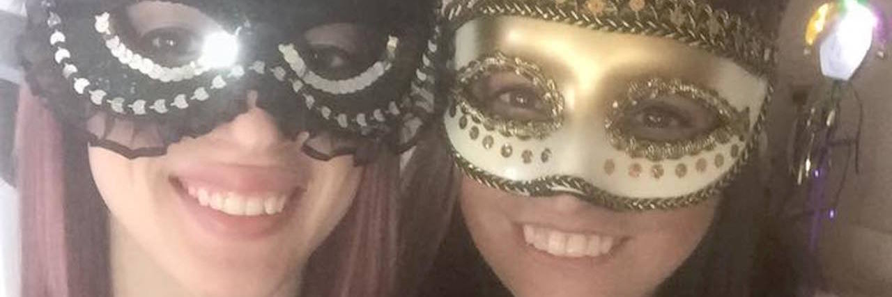 Celebrating New Year's With Scleroderma two women wearing gold and silver masks