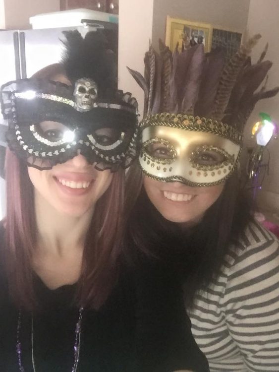 two women wearing gold and silver masks