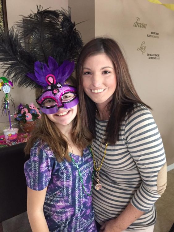 the author with a girl wearing a purple mask