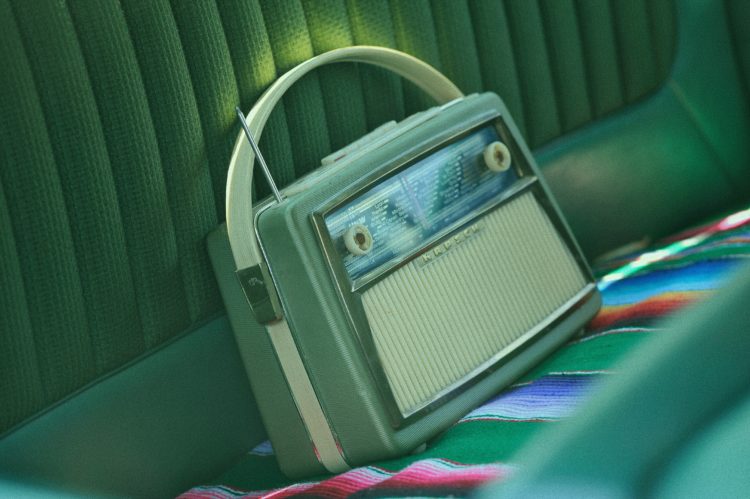old green radio in backseat of car