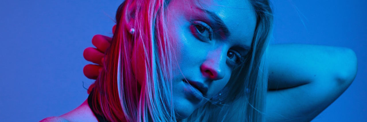 8 Reasons I'm Afraid of Dating as Someone With Anxiety woman blue and pink background