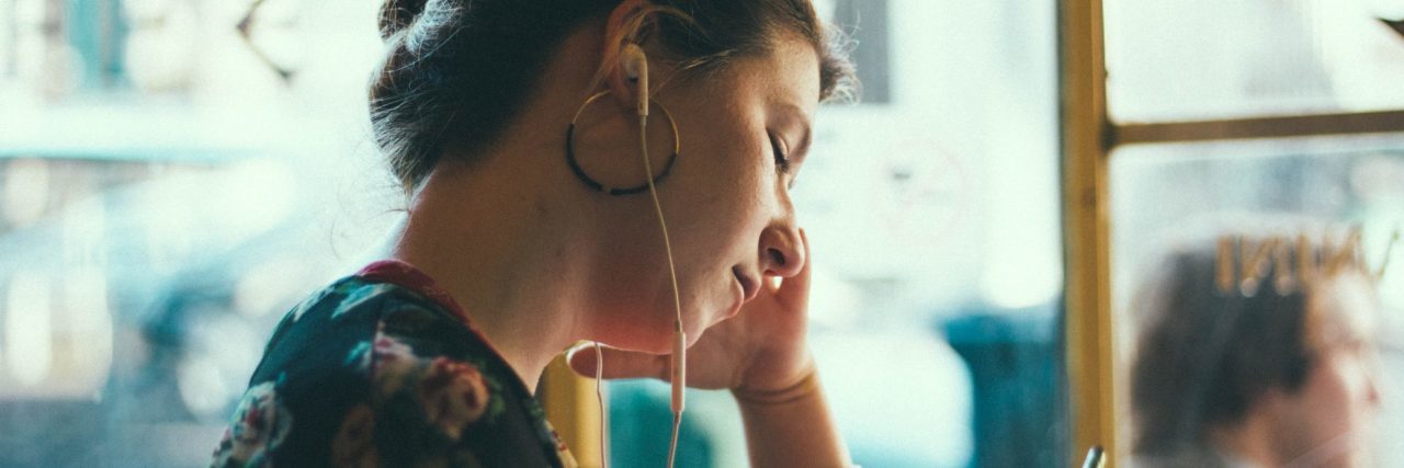 Essential Items for an Anxiety 'Crisis Kit' woman with earphones alone in public