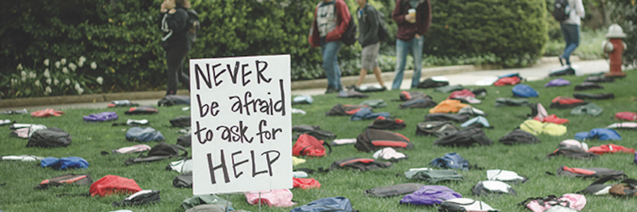 How the 'Send Silence Packing' Exhibit Is Raising Suicide Awareness backpacks on ground of college campus for the "Send Silence Packing" project