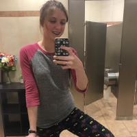 Emma taking a selfie in her leggings.