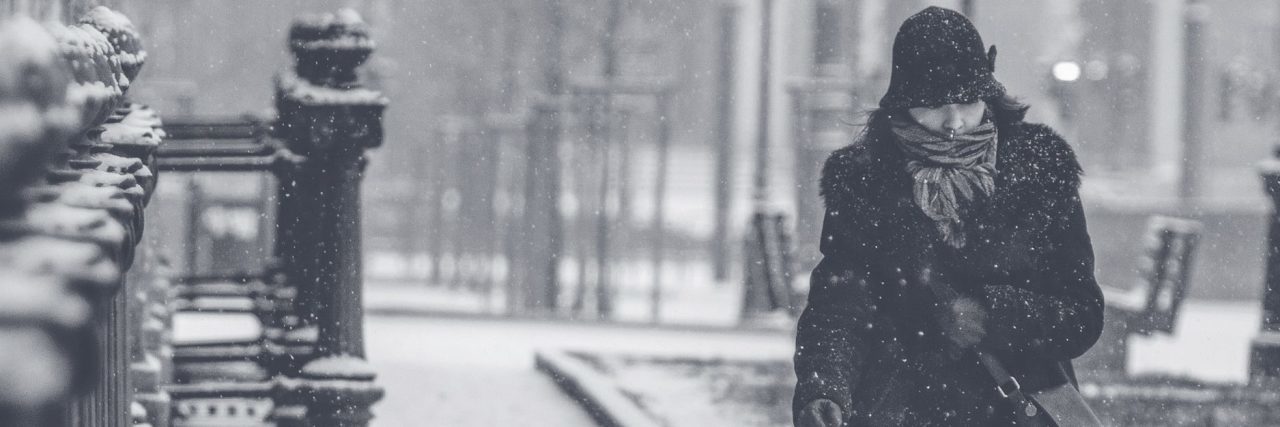 To Those Who Don't Understand My Depression woman walking along street in snowstorm