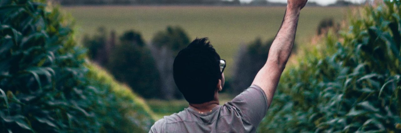How to Have Hope for Mental Health Recovery asian man holding sparkler to sky in country lane with storm clouds overhead hope concept