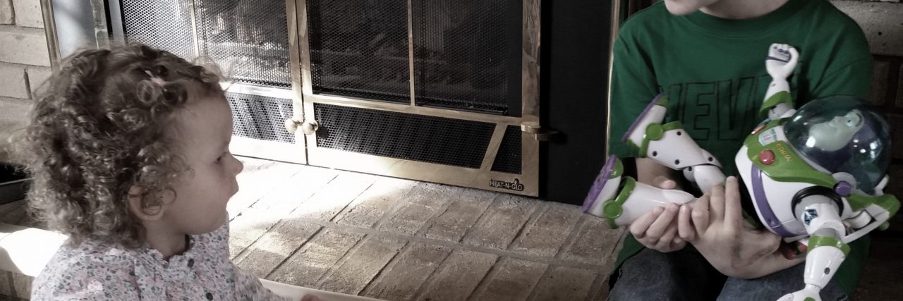 Simplicity and Minimalism Helps in Managing Life With Dup15q brother and sister playing with buzz lightyear