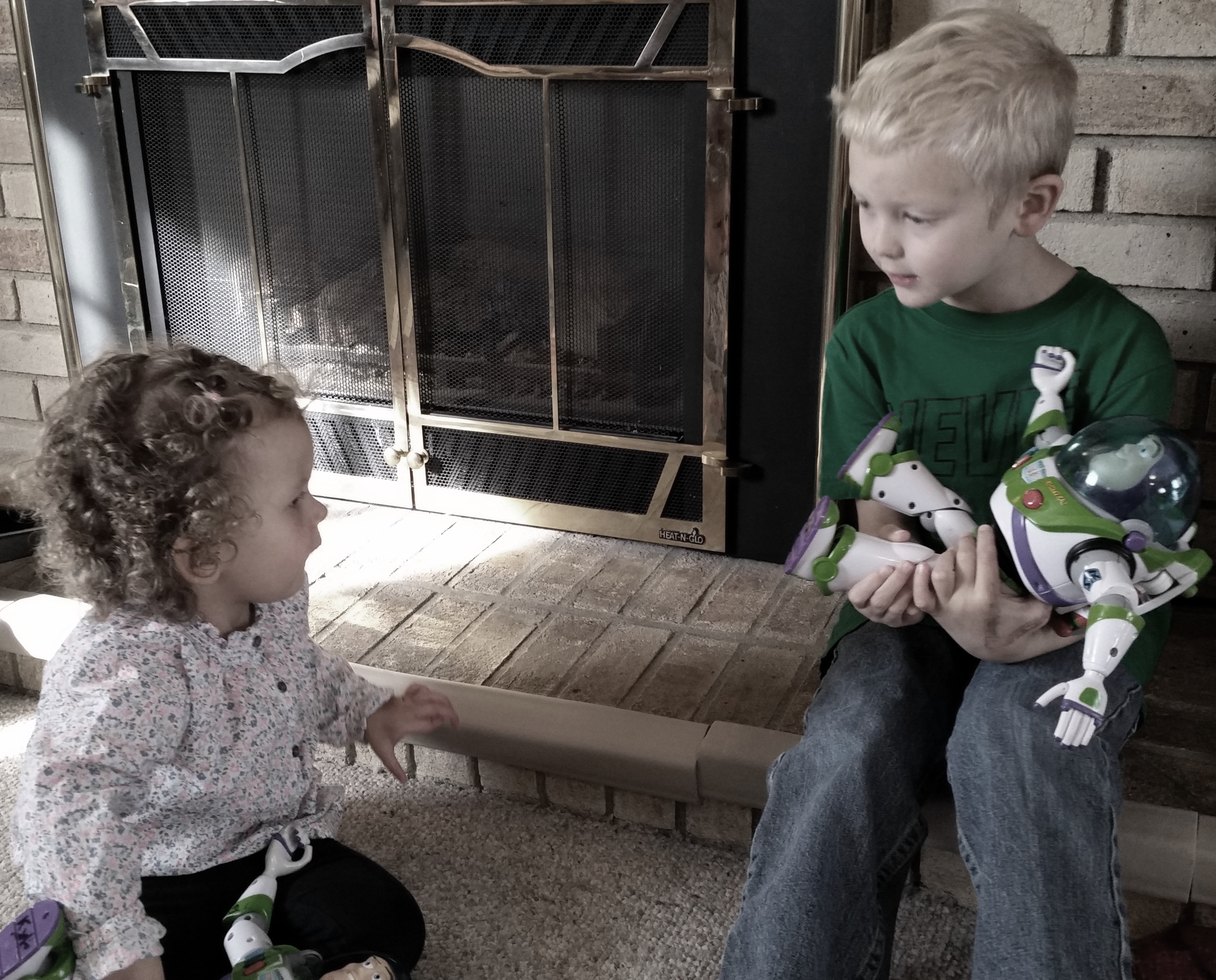 brother and sister playing with buzz lightyear