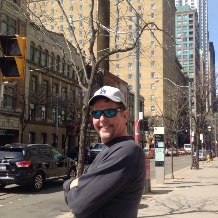 man with hat smiling at camera