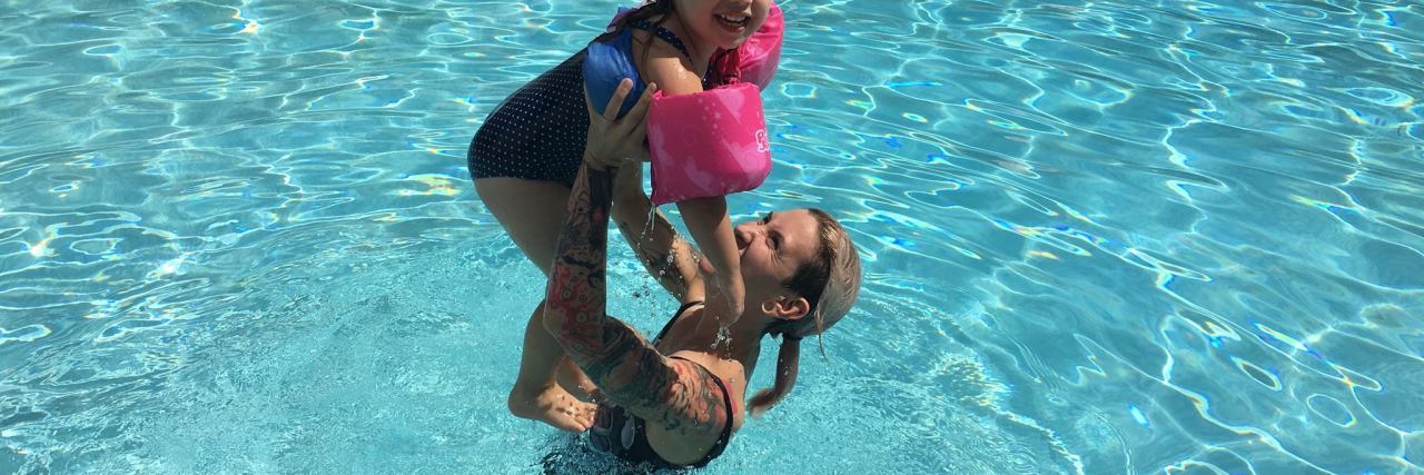 mother and daughter in pool