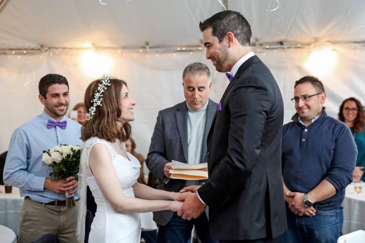 nicole carfagna and danny rios holding hands at the altar