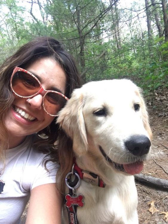 woman wearing sunglasses smiling with dog