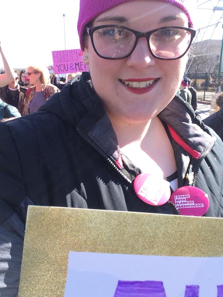 a woman with a sign that says autistic women for equality