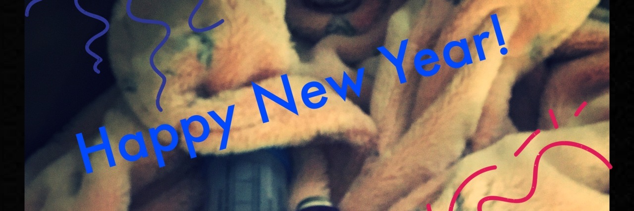 Being Sick on New Year's Eve With Chronic Illness blanket covered with pill bottles and text saying 'happy new year!'