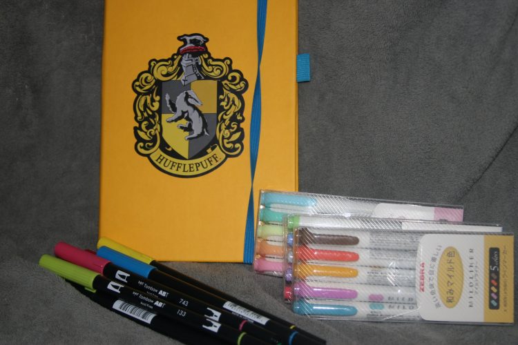 bullet journal with harry potter sticker and colored sharpies