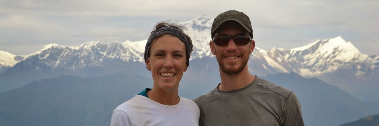 How Yoga Helped Me Battle Mold and Lyme Disease Annie and Brad smiling in front of a mountain range in Colorado