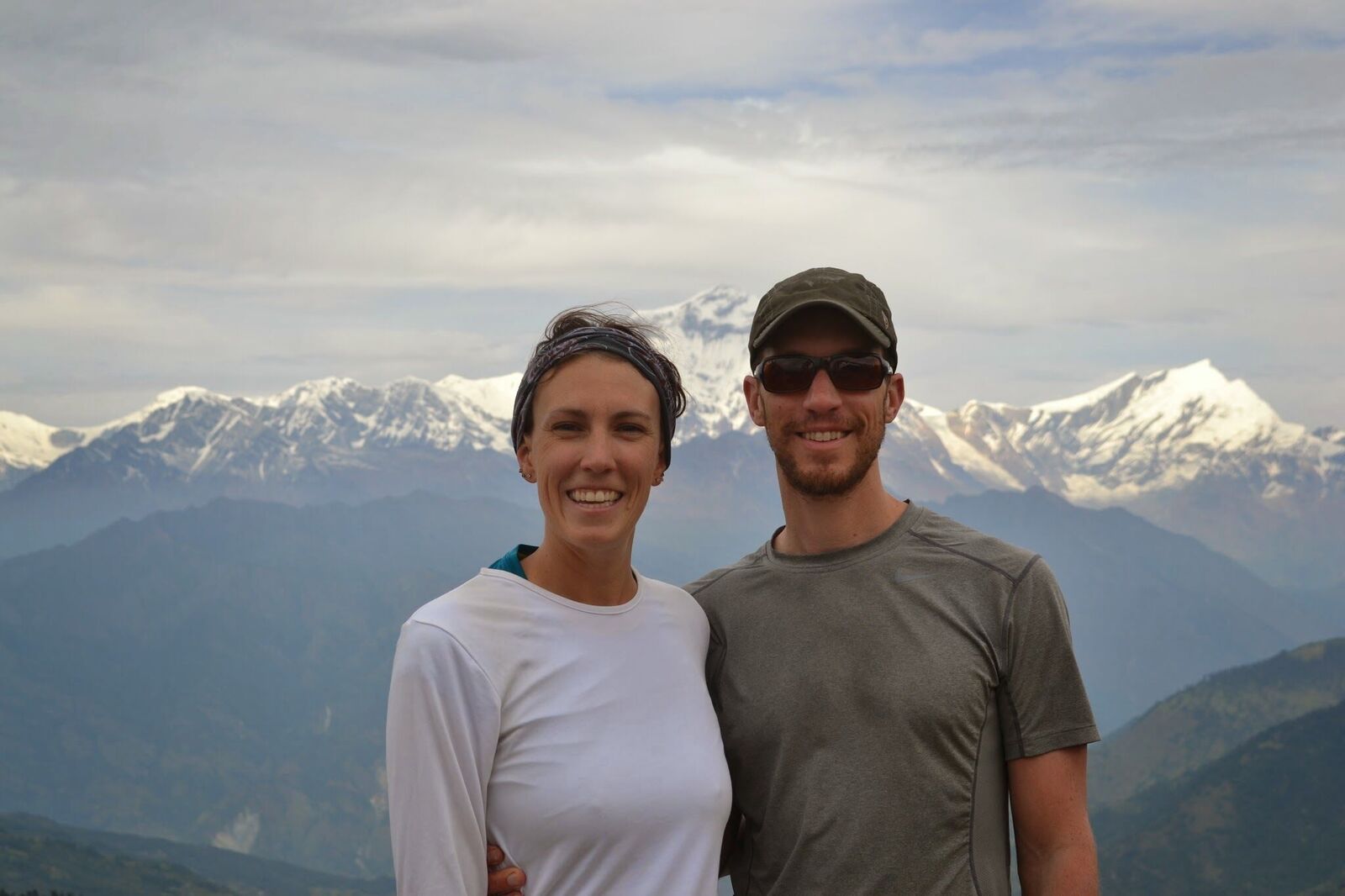 Annie and Brad smiling in front of a mountain range in Colorado