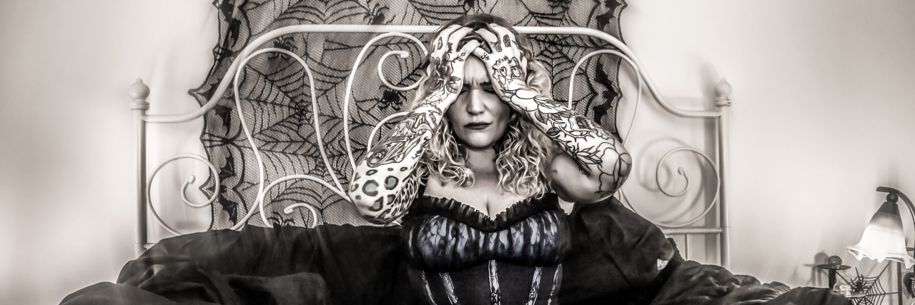 Why I Find My Chronic Fatigue to Be Worse Than My Chronic Pain An image of the writer with a blur affect of her in bed.