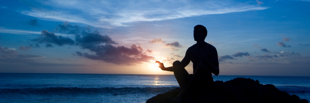 Following My Breath After Being Diagnosed With a Rare Blood Cancer Keeping sun - young man meditating on the beach