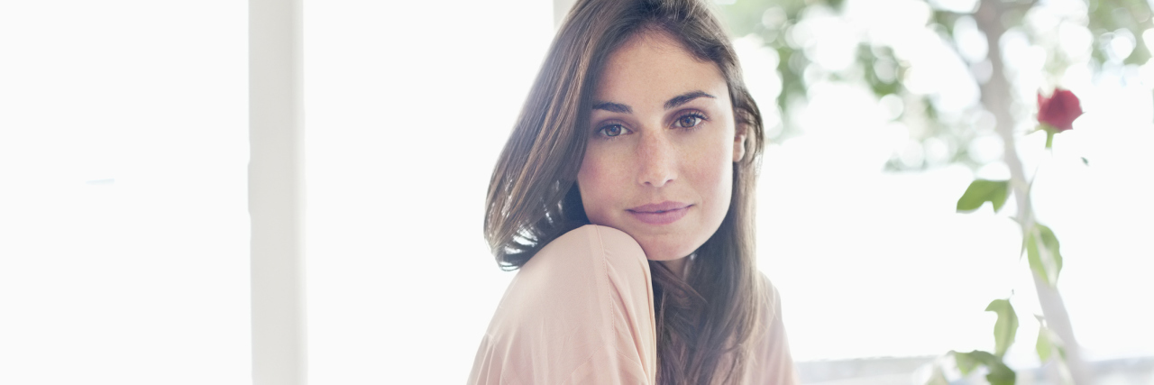 The Power of Saying 'No' When You're Chronically Ill A confident looking woman sitting at a desk.