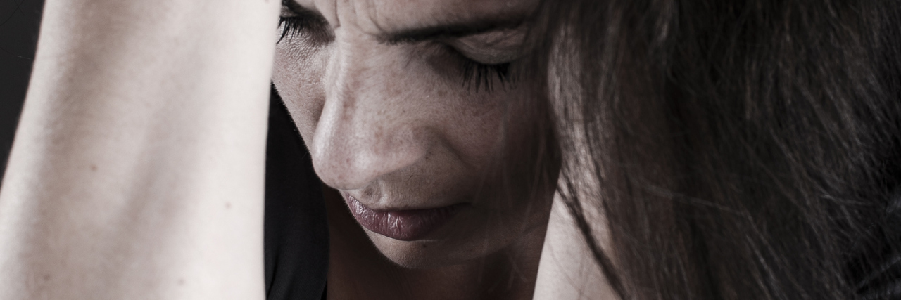 The One Thing That Got Me Through My Psych Ward Nightmare depressed woman with hands in hair looking desperate