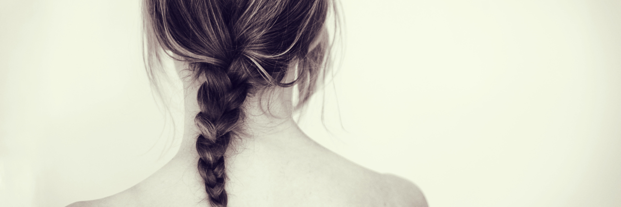 Girl or woman with braid from behind