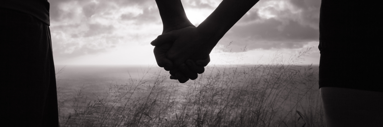 Living with CRPS And Understanding Others' Pain Couple holding hands in the sunset, Hawaii, USA.