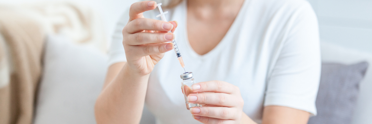 Type 1 Diabetes Affects My Mental Health A woman filling a syringe with medication.