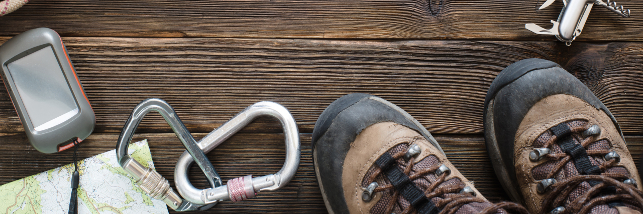 10 Tips on Surviving Survival Mode Travel equipment for mountain trip on wood floor. Top view