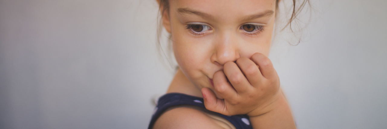 What to Know If Your Child Has Selective Mutism Young girl covering her mouth with her hands