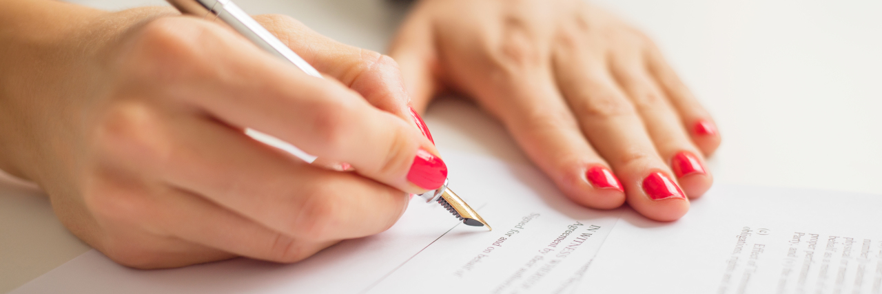 Letter to the Officials Reviewing My Disability Benefits Application Female writing on paper with pen.