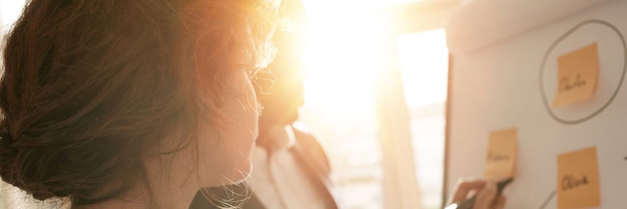 What It's Like Being an Entrepreneur With Anxiety A woman writing on a board