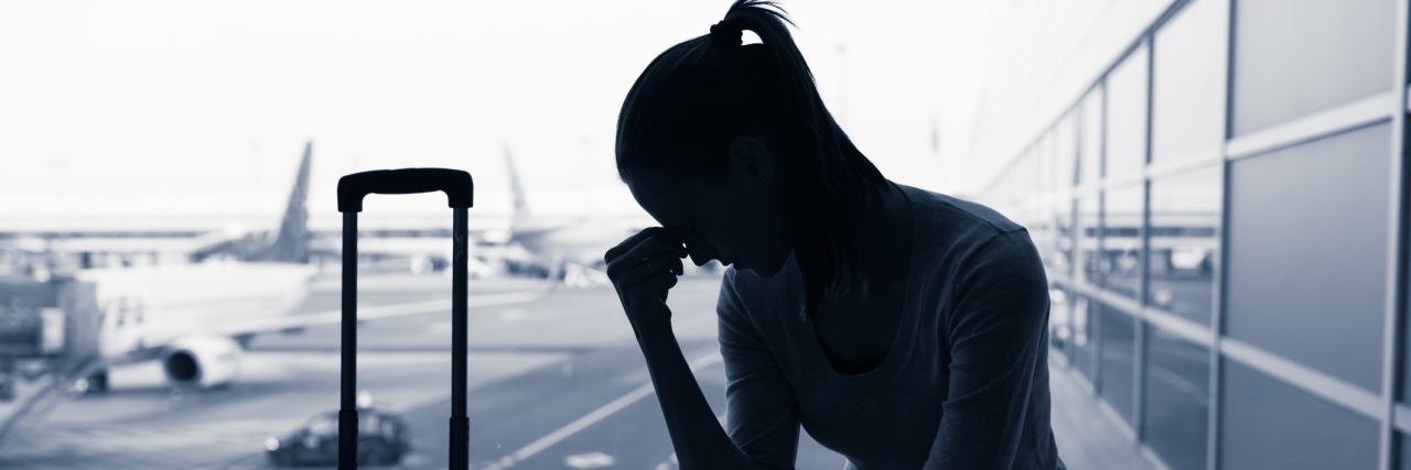 Why Through TSA Is Difficult When You're Chronically Ill A stressed out silhouette of a woman at an airport with an airplane blurred behind her.