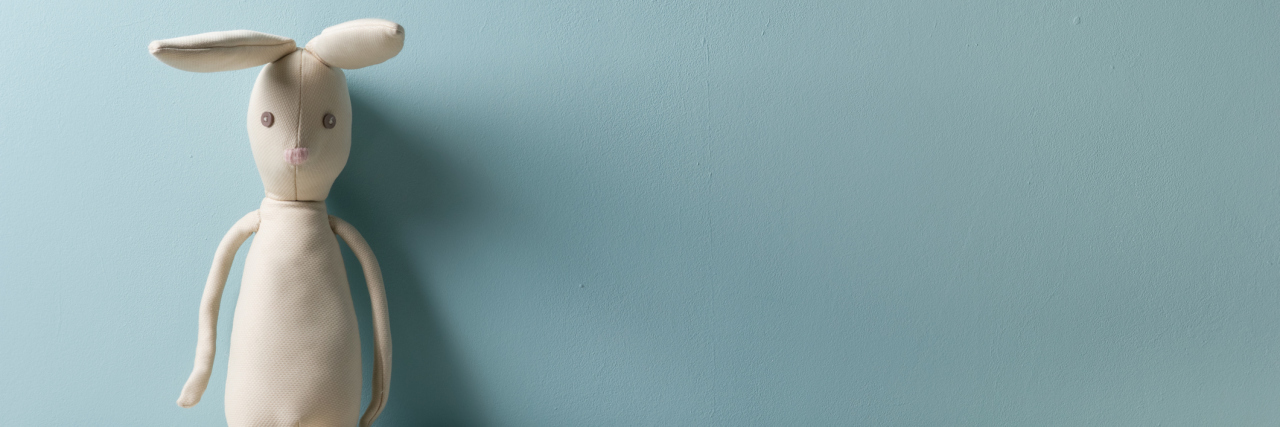 How 'The Velveteen Rabbit' Relates to My Eating Disorder Recovery rabbit toy sitting on couch against blue wall velveteen rabbit