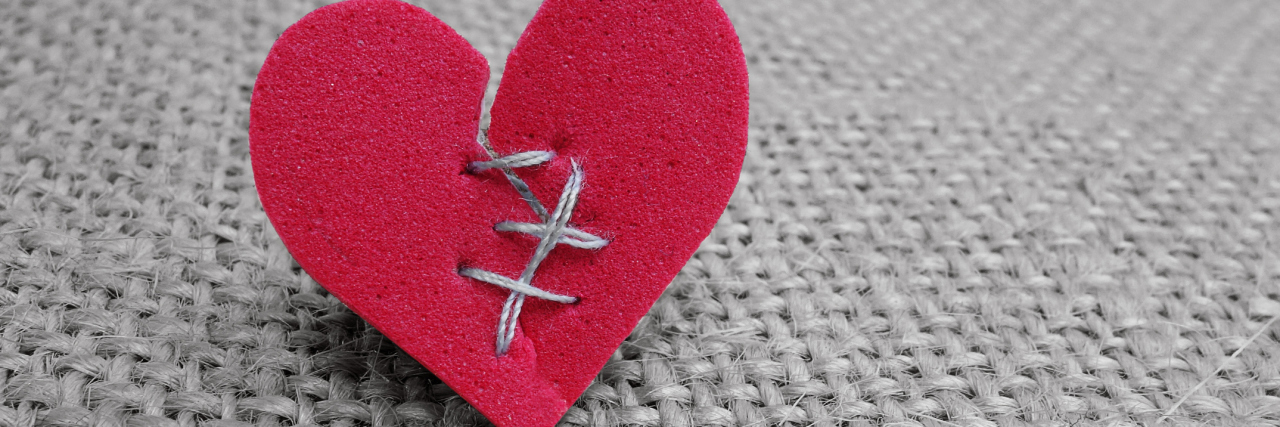 Borderline Personality Disorder, Heartbreak and Valentine's Day Broken red heart with white thread stitches