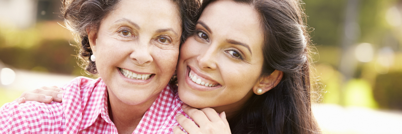 Navigating Multiple Sclerosis as a Mother/Daughter Care Partner Team mother and daughter smiling together in the park