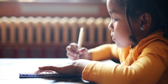 New York First State to Require Mental Health Education in Schools A young girl writing in a classroom