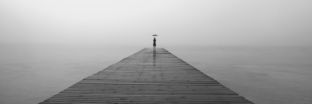 Facing My Own Mortality After Being Diagnosed With Leukemia at 24 woman with black umbrella looking infinity in a surreal place