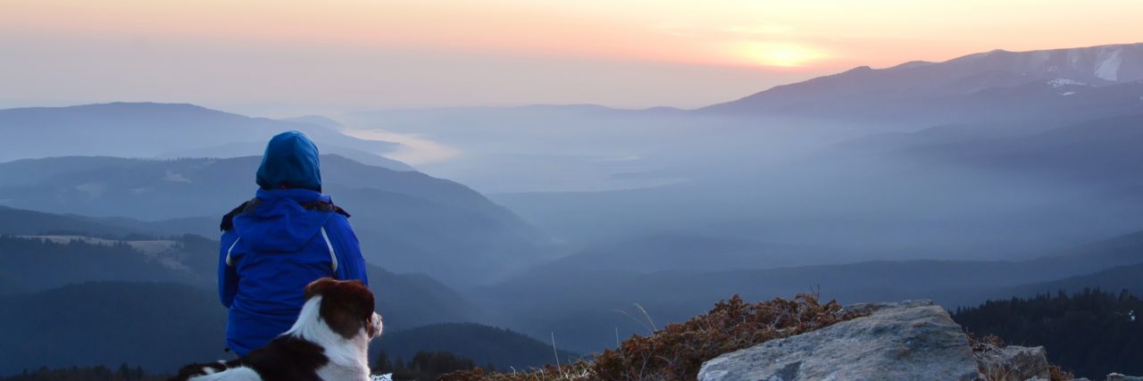8 Self-Care Tips for Cancer Survivors Young woman with dog watching sunrise