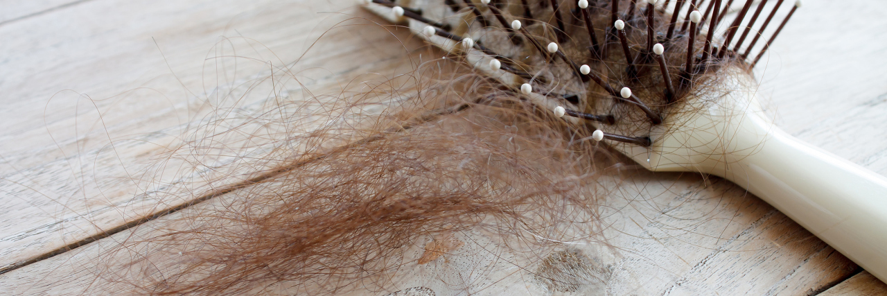hairbrush with a clump of lost hair