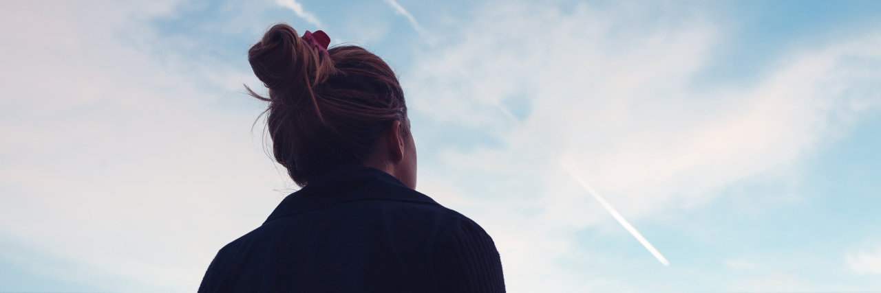 My Life With Narcolepsy The silhouette of a woman looking at sunset in the distance.