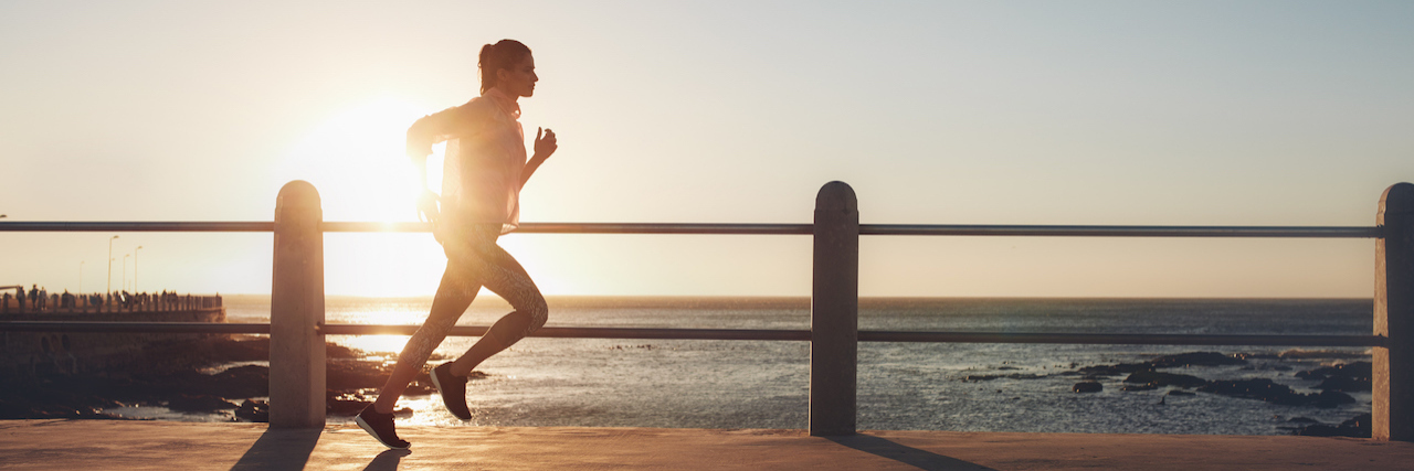 How Running Helped Alisha Perkins Overcome Anxiety A woman funning on a pier