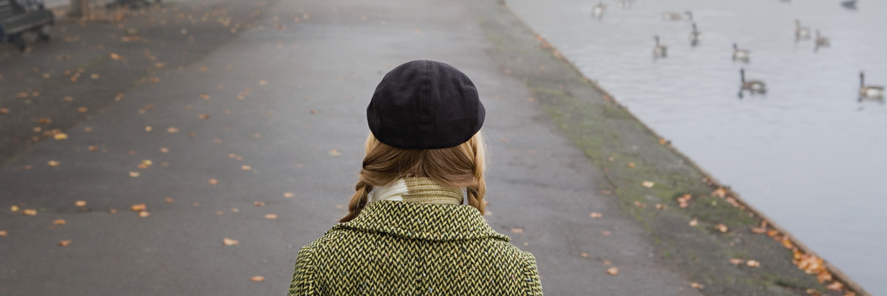 When I Remember the Day I Was Diagnosed With MS A woman looking down a pathway of a park on a dreary, overcast day.