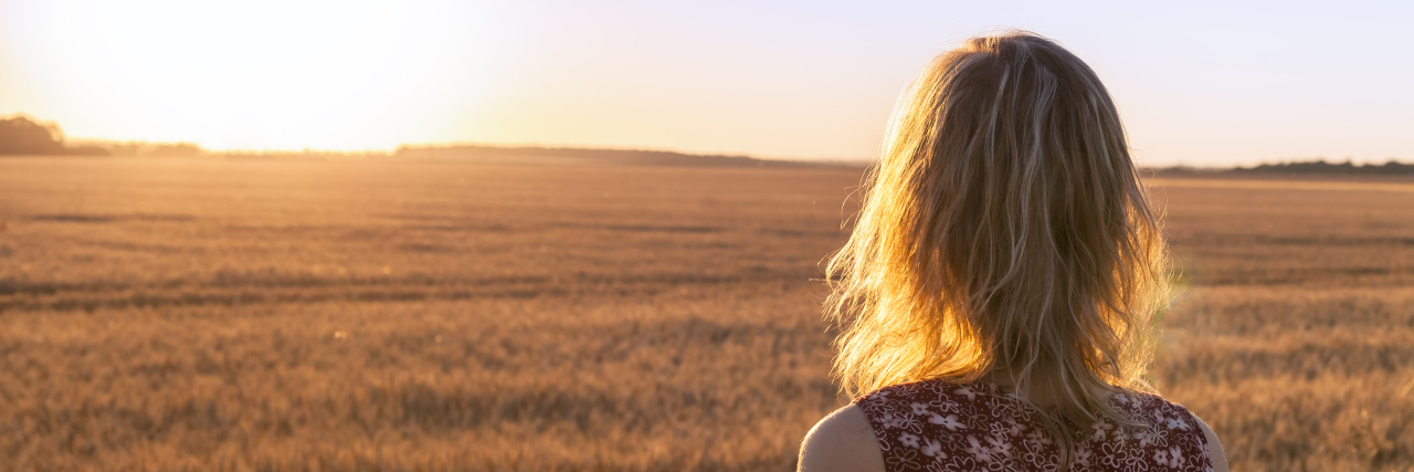 From Pregnant to Cancer Patient and Back Young blond girl in yellow field at sunset, summer