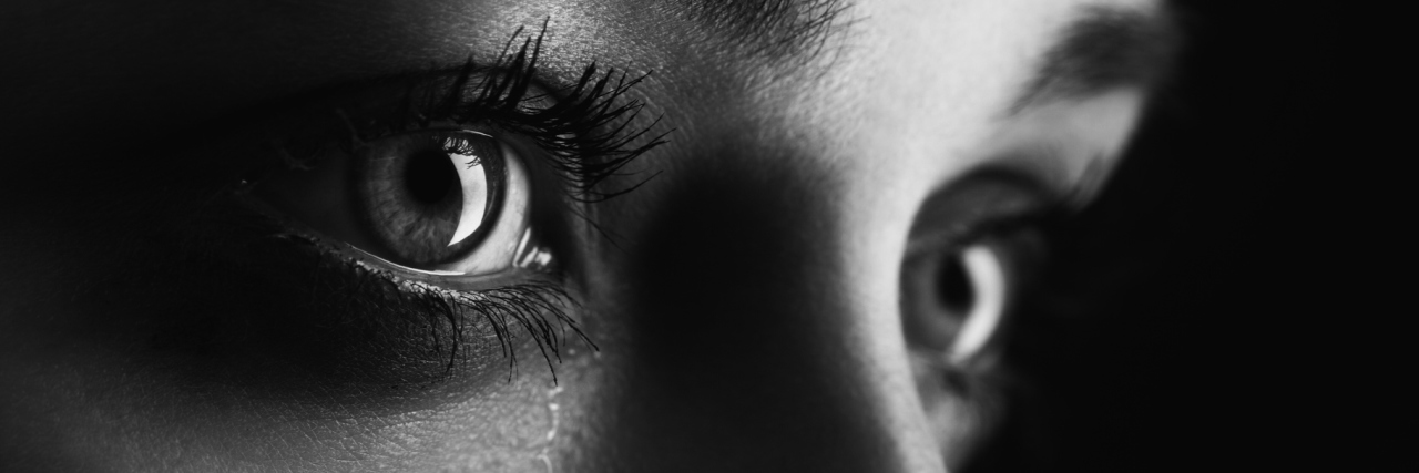 Working Through Grief After My Ankylosing Spondylitis Diagnosis black and white close-up photo of a woman crying