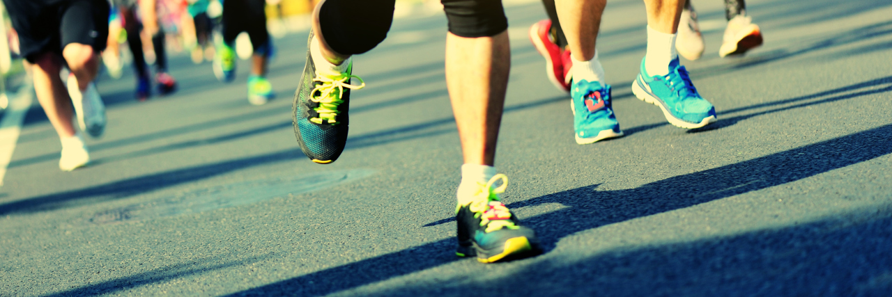 How Living With a Genetic Disease Is Like Running a Race Without a Finish Line legs and feet of people running a race